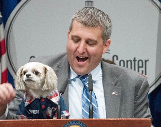 Speaker at podium with dog during 2018 Pennsylvania Humane Lobby Day