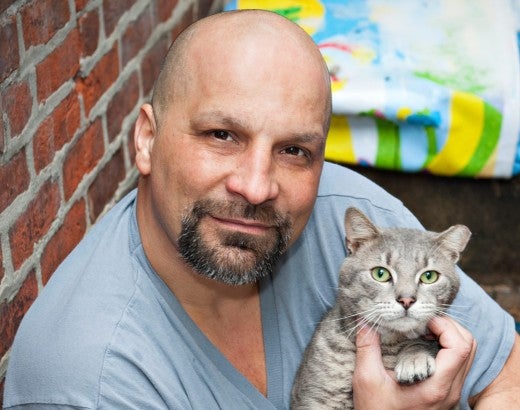 Man holding his grey cat