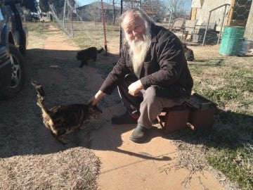 Man petting a cat outside